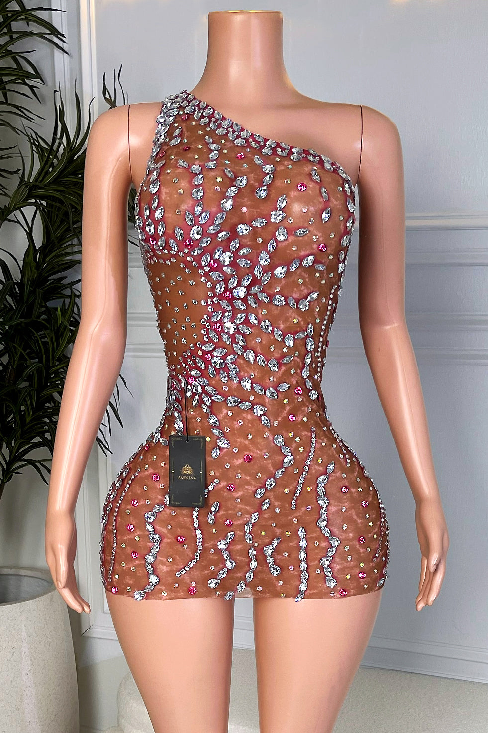 One shoulder nude illusion brown mesh rhinestone mini dress with silver leaf crystal pattern and pink accents, front view