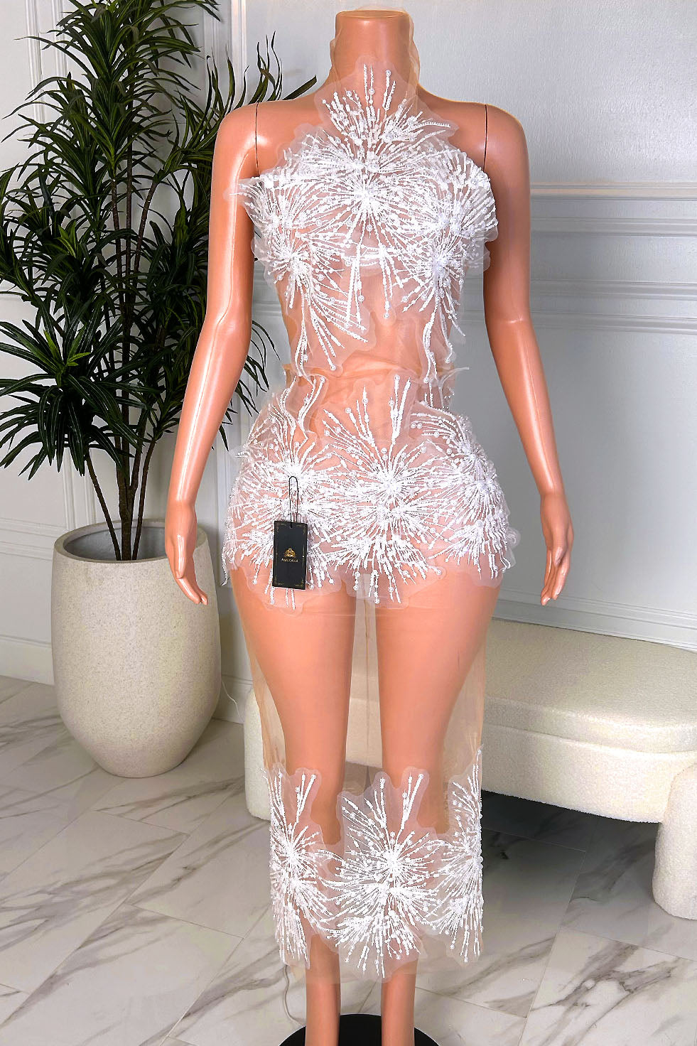 White sheer illusion high neck dress with starburst appliqués and a fitted mini silhouette with long sheer overlay, front view