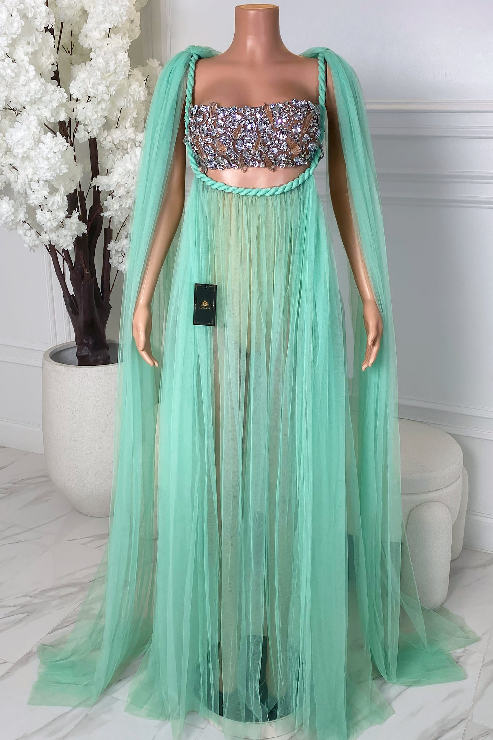 Front view of the Azmira Teal Veil Set featuring a crystal embellished bandeau top, sheer teal tulle skirt overlay, and flowing cape-style shoulder drape