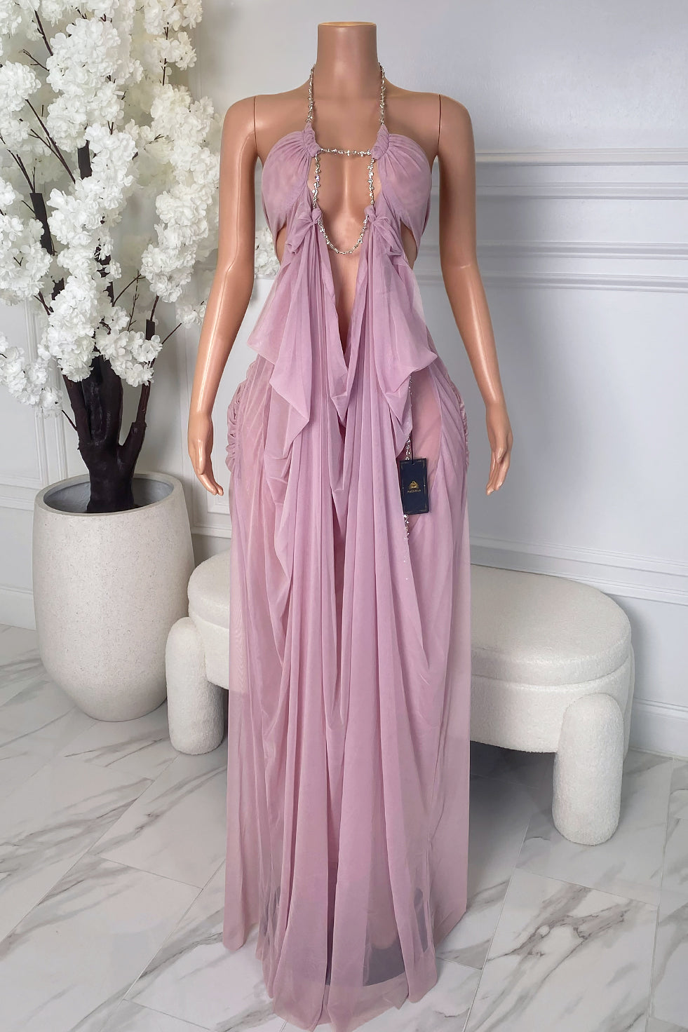 Front view of lilac sheer maxi dress with rhinestone chain neckline, deep open front, gathered bust, and flowing draped fabric