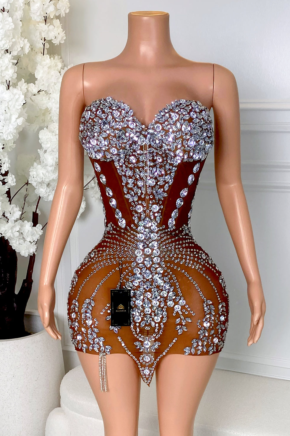 Front view of brown sheer mesh rhinestone mini dress with strapless sweetheart neckline, silver rhinestone pattern, structured bodice, and body-hugging fit