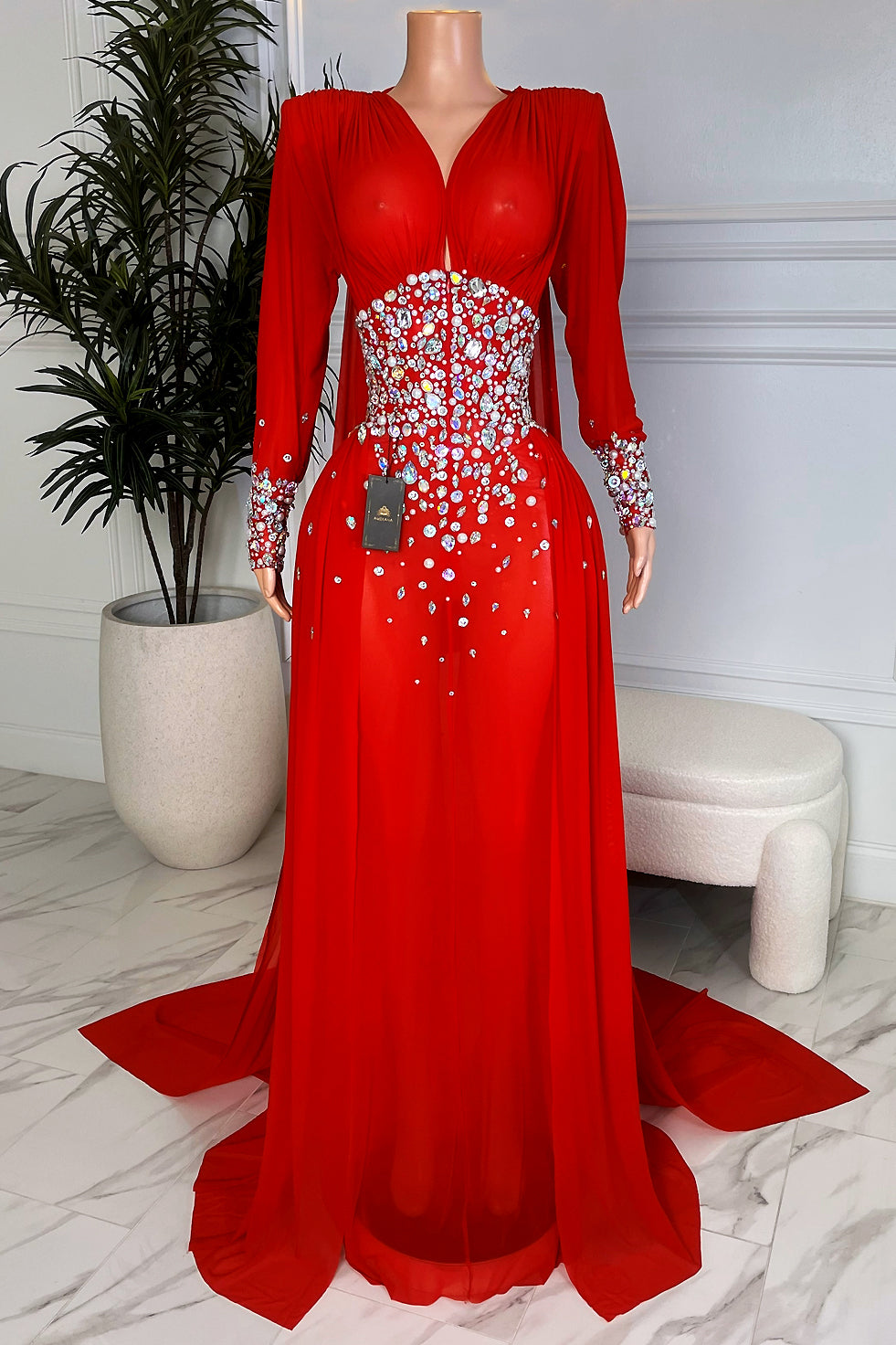 Red opal rhinestone maxi gown with long sleeves and dramatic train from Amekana, front view on mannequin