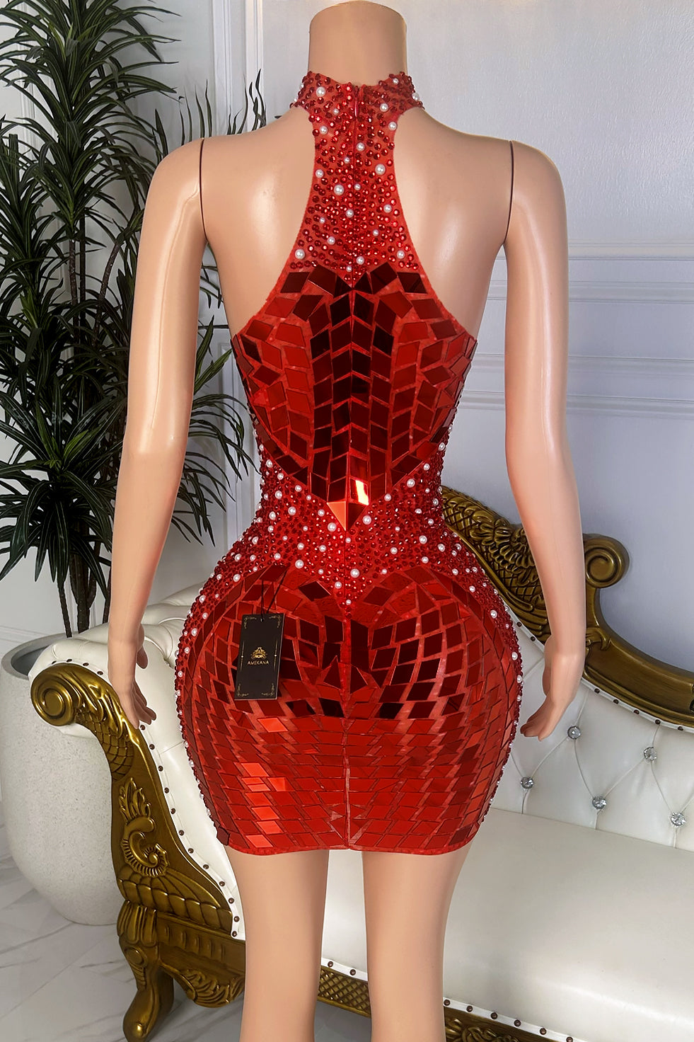 Back view of a red mirror crystal mini dress with high neck racerback design, open shoulders, geometric embellishments, and fitted silhouette.