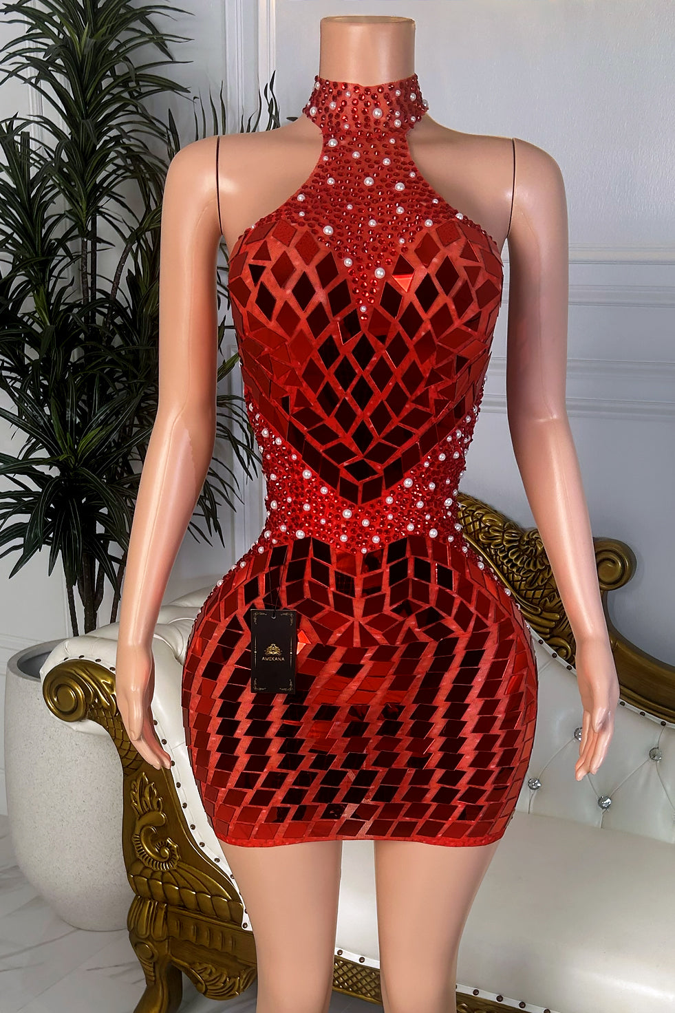 Front view of a red high neck mini dress with mirror-style geometric embellishments, rhinestone accents, pearl-like details, and fitted bodycon silhouette.